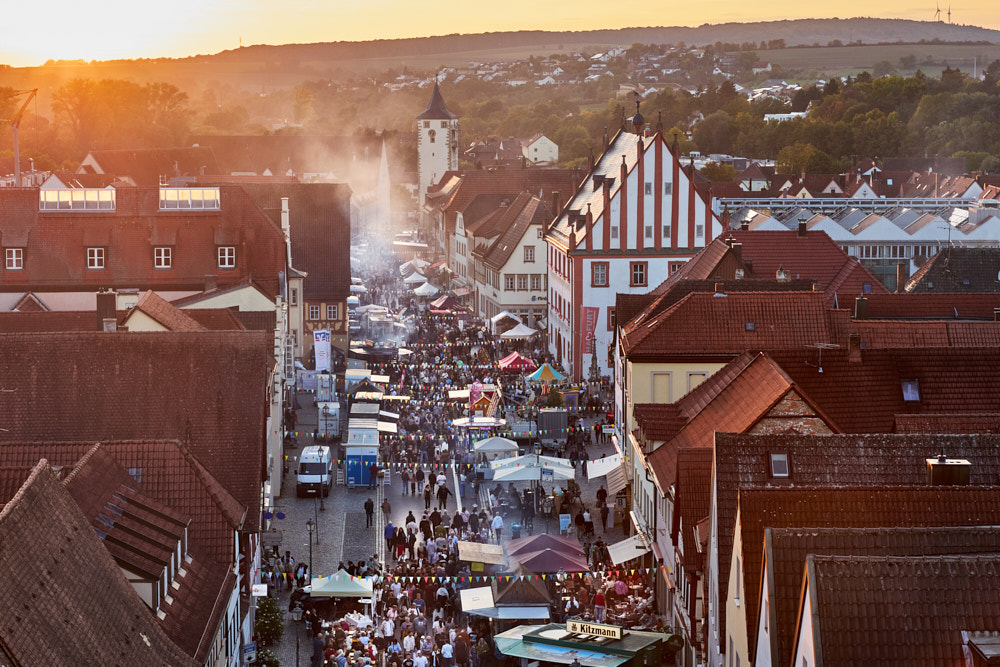 Menschenmenge auf dem Ha&szlig;furter Stra&szlig;enfest bei Sonnenuntergang, &uuml;ber D&auml;cher, Oliver Giel